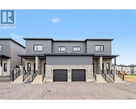 A large house with a snowy roof and garage doors.