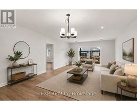 A well-lit, spacious living room with a large couch, a coffee table, and a chandelier.