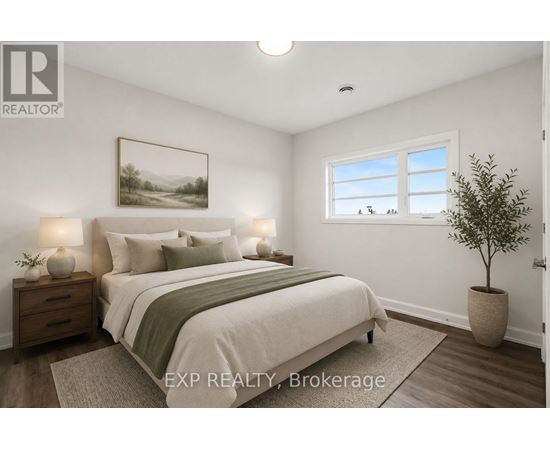 A bedroom with a bed, nightstands, and a potted plant.