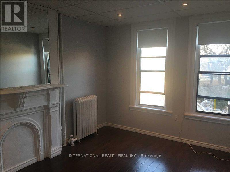 A room with a fireplace and a window.