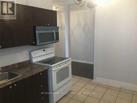 A kitchen with a stove top oven and microwave above it.