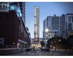 A city street with a tall building in the background at dusk.