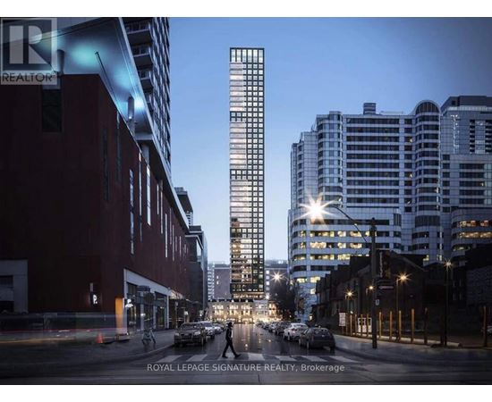 A city street with a tall building in the background at dusk.