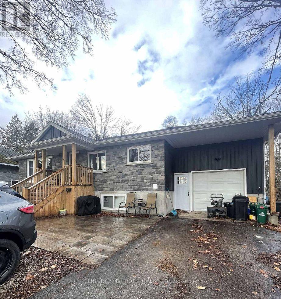 A grey house with a garage and a driveway.