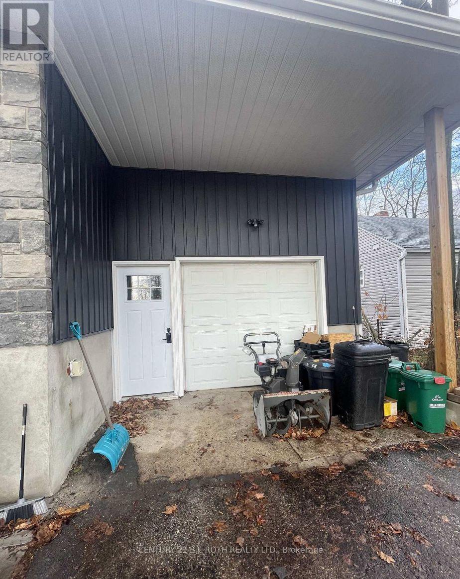 A garage with a white door and a black wall.