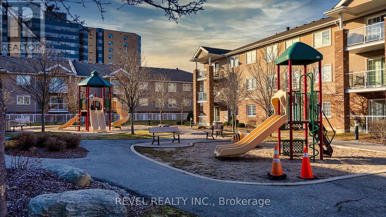 A playground with a slide and a green roofed structure.