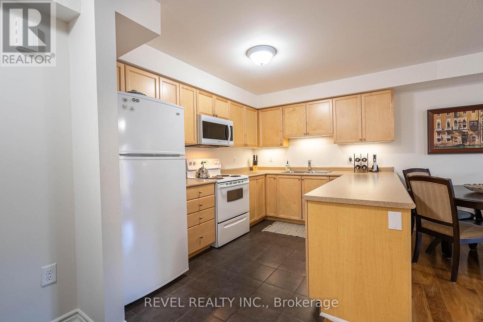 A kitchen with wooden cabinets and a white refrigerator.