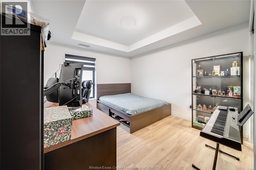 A bedroom with a bed, desk, and chair.