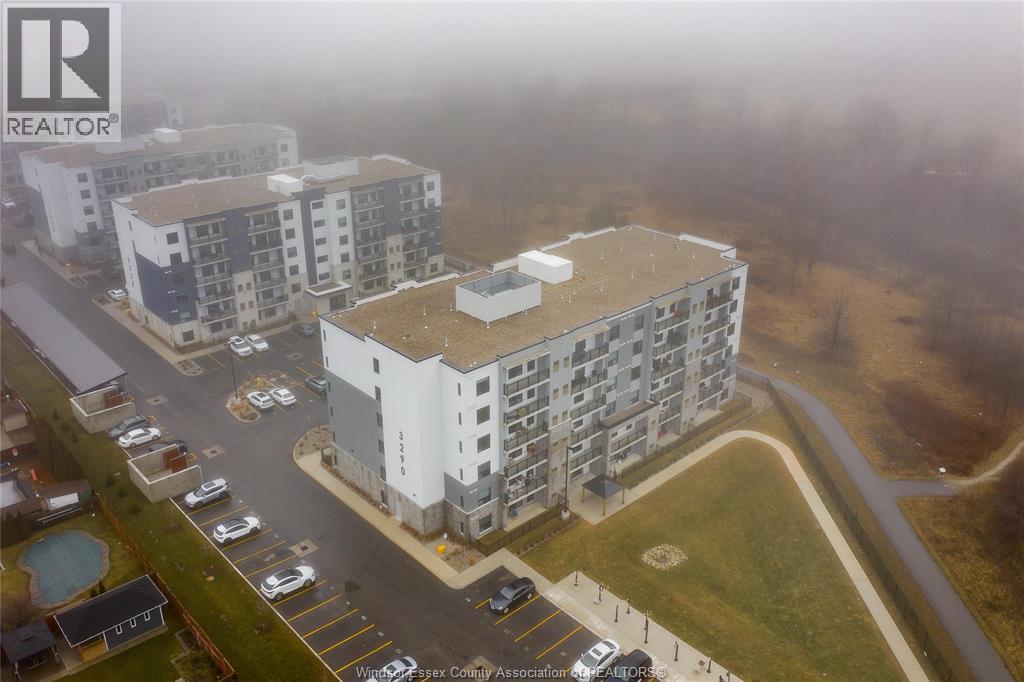 A foggy day at a realtor's association building with cars parked in the lot.