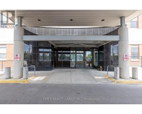 The entrance to a building with a glass door and a no parking sign.
