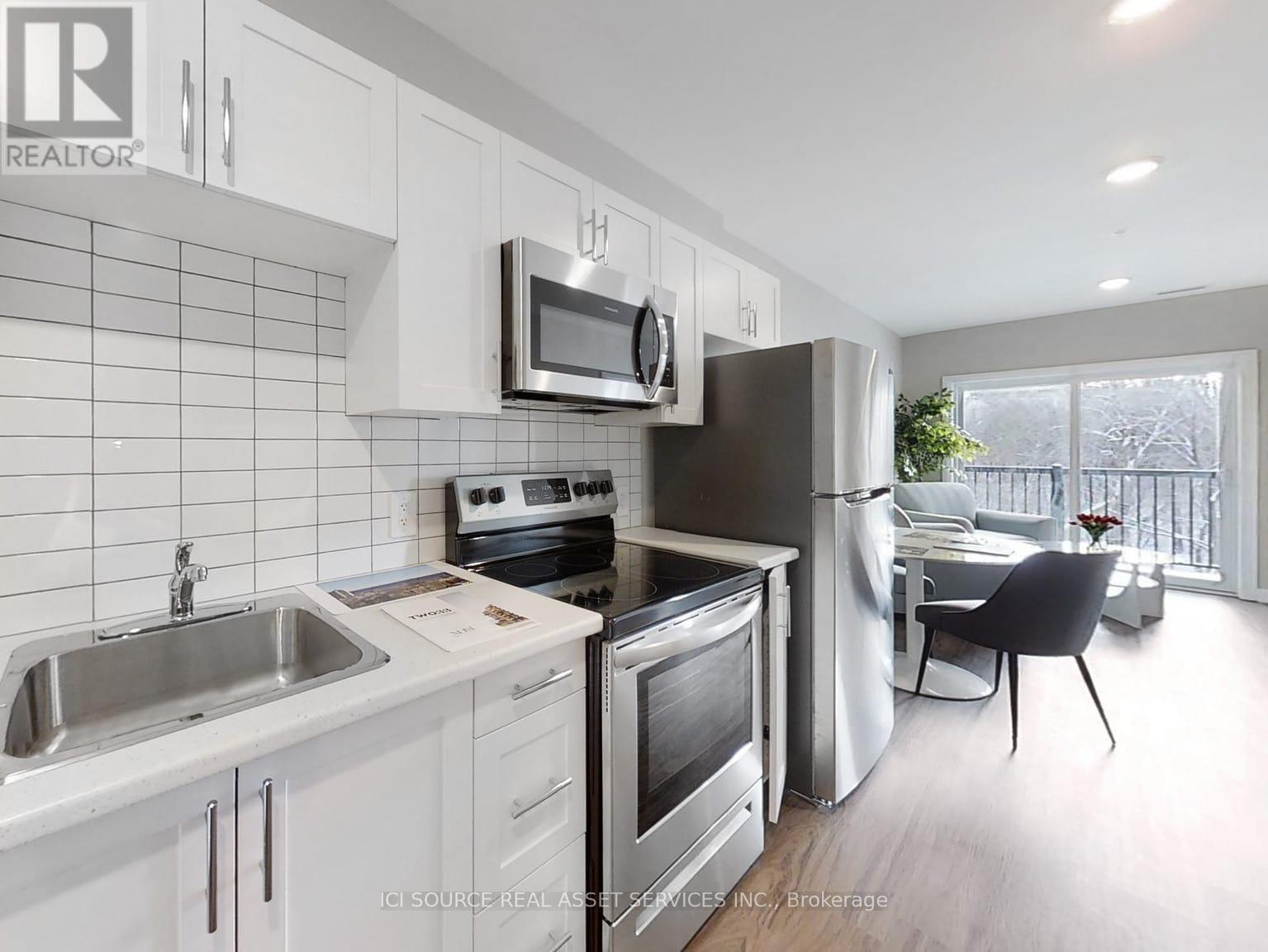 A kitchen with white cabinets and stainless steel appliances.