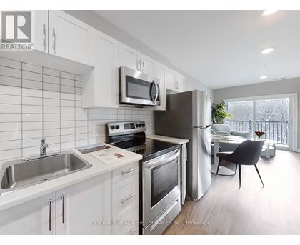 A kitchen with white cabinets and stainless steel appliances.