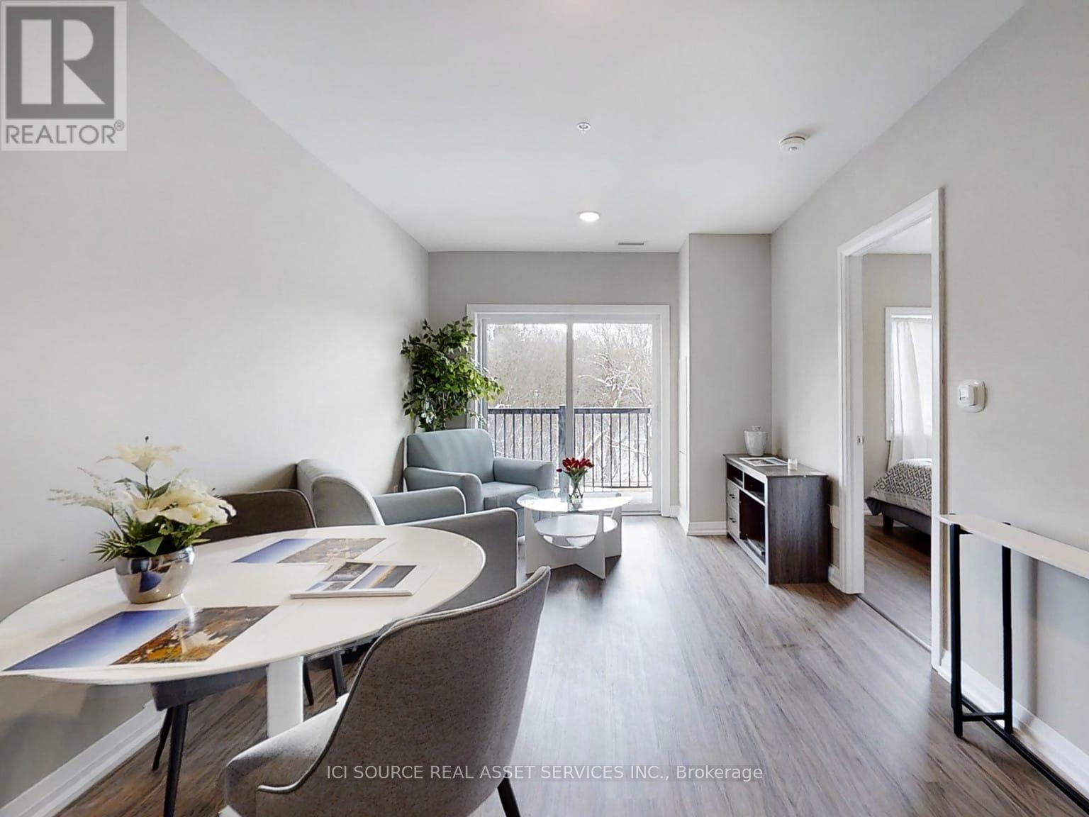 A well-lit, spacious living room with a dining table and chairs.