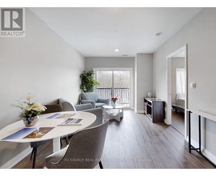A well-lit, spacious living room with a dining table and chairs.