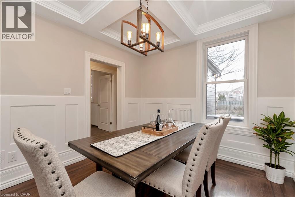 A dining room with a wooden table and chairs.