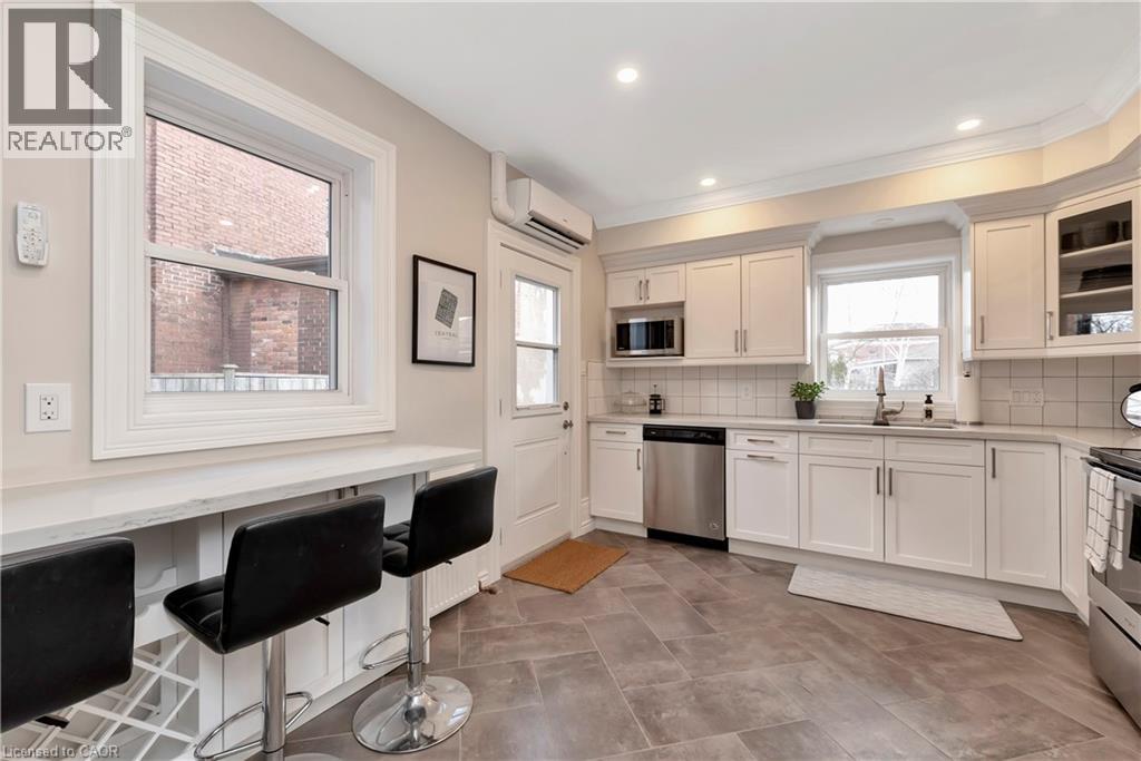 A kitchen with a dining table and chairs.