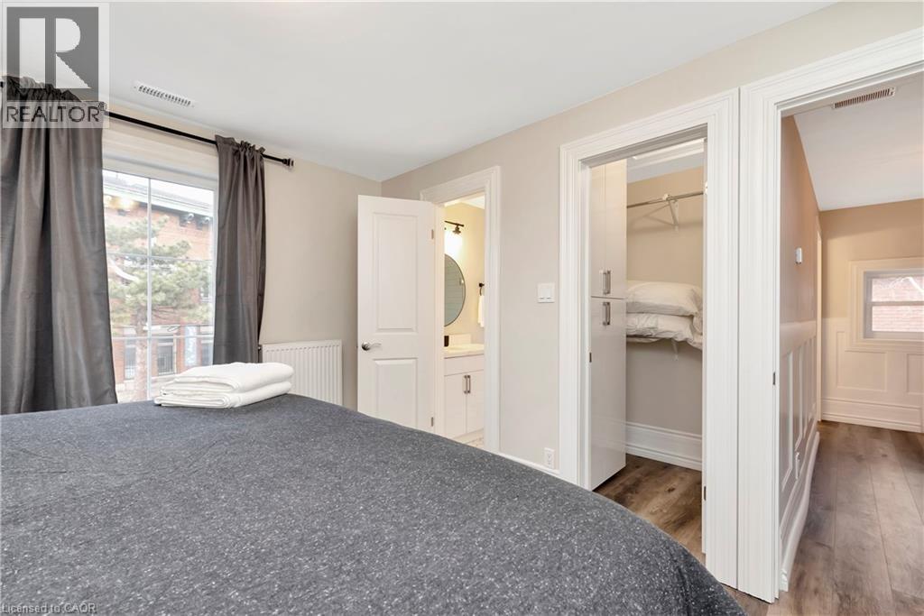 A bedroom with a large bed and a small closet.