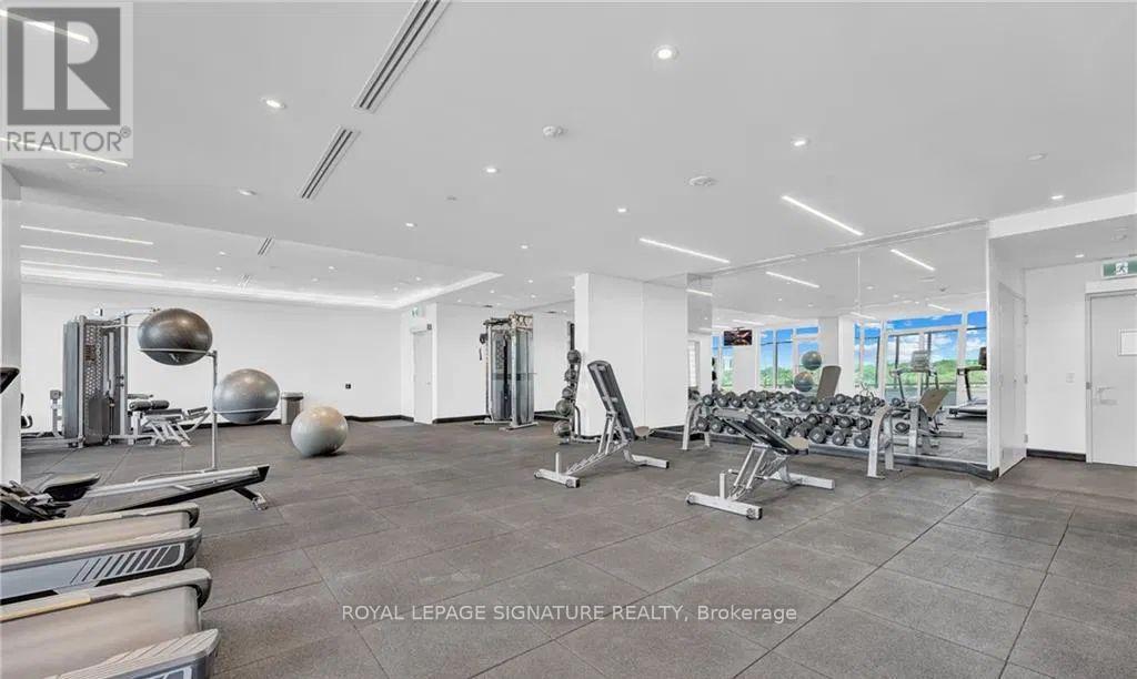 A gym with a variety of equipment including weights and exercise machines.