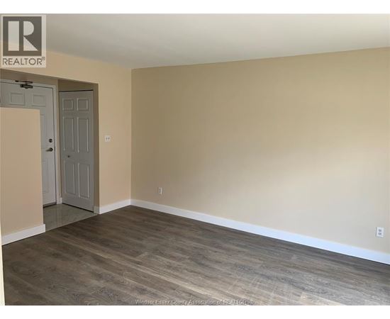 A room with a wooden floor and a door.