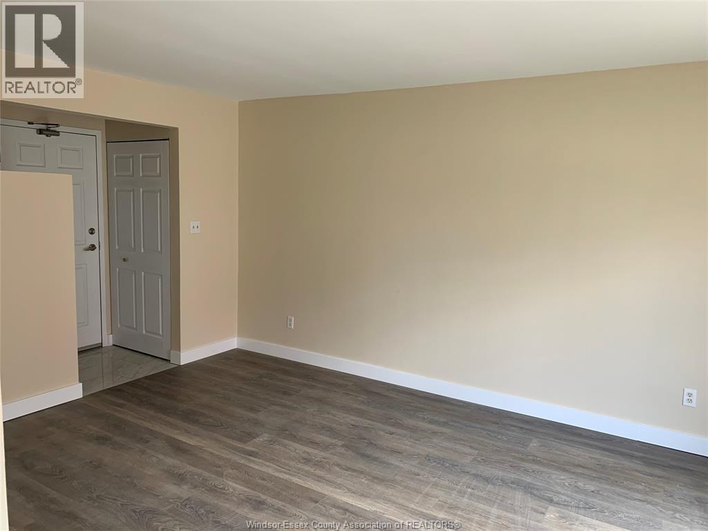 A room with a wooden floor and a door.