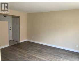 A room with a wooden floor and a door.