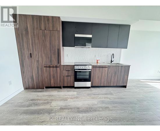 A modern kitchen with dark wood cabinets and a stainless steel oven.