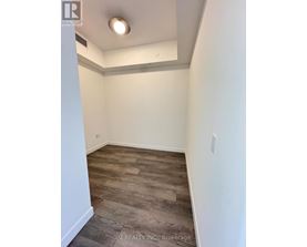A room with a wooden floor and white walls.