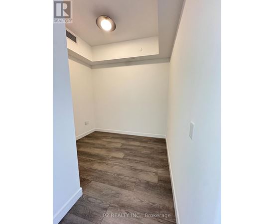 A room with a wooden floor and white walls.