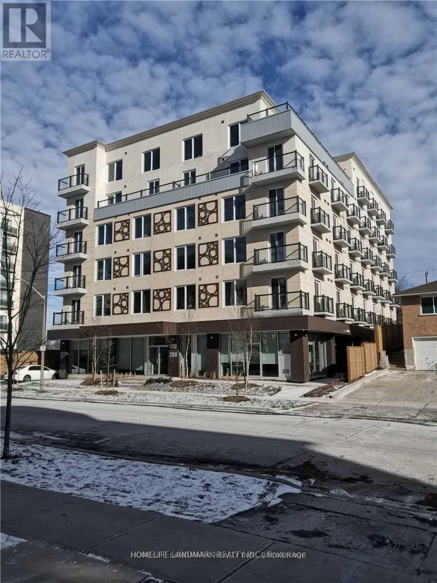 A large, multi-story residential building with balconies and a flat roof.