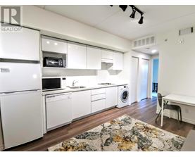 A kitchen with white appliances and cabinets.