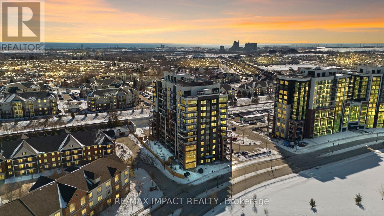 A cityscape with apartment buildings and a sunset.