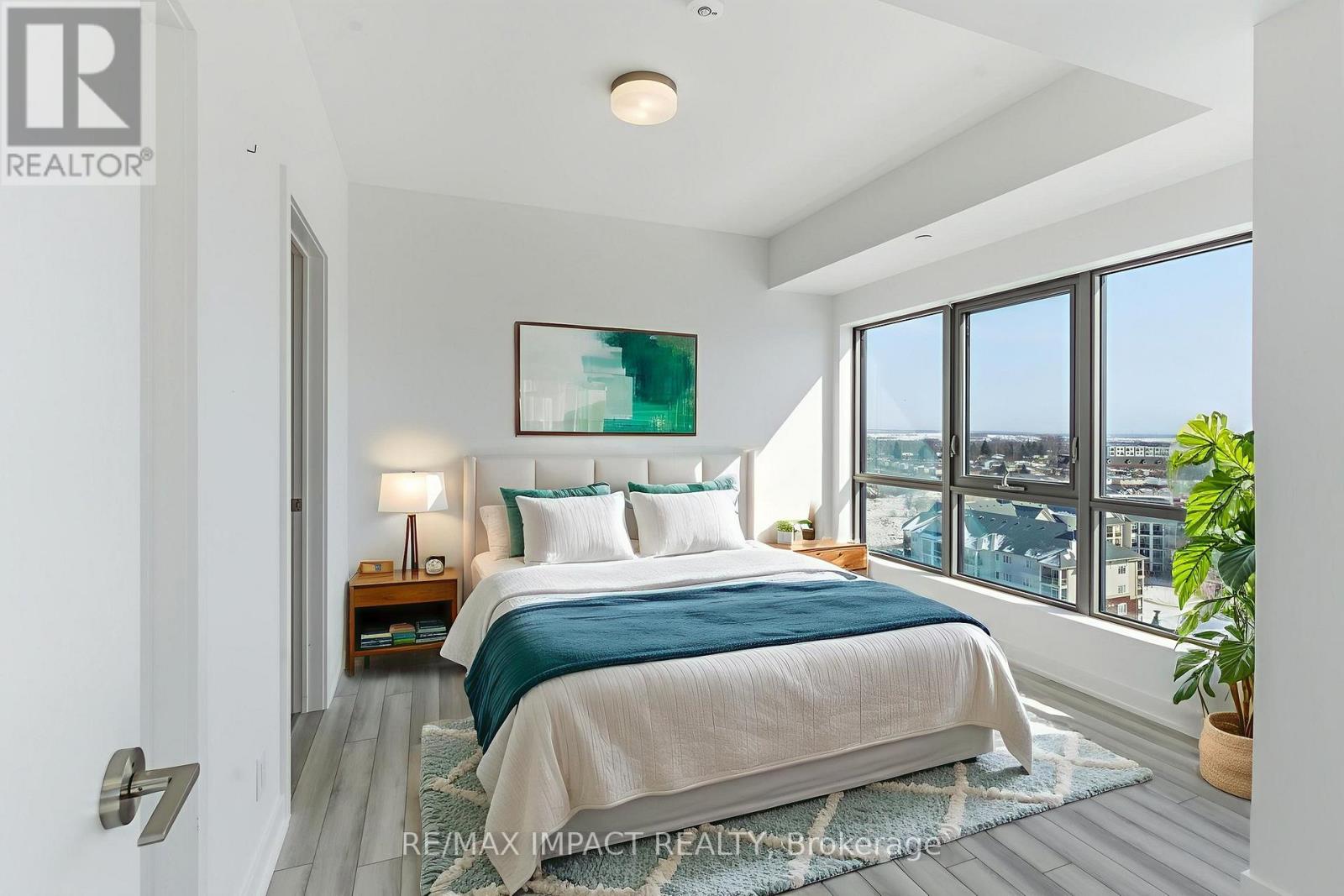 A bedroom with a large bed and a view of the city.
