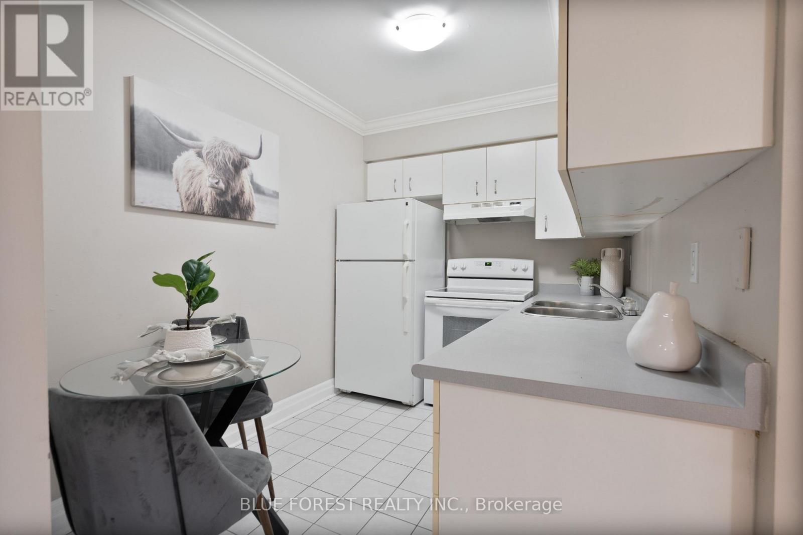 A small kitchen with a table and chairs.