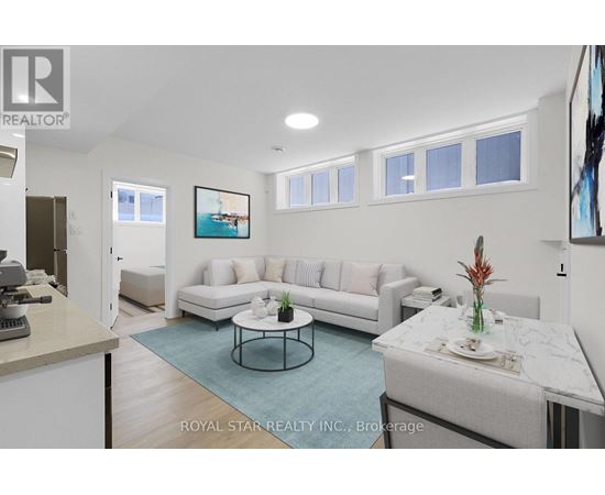 A living room with a white couch and a coffee table.