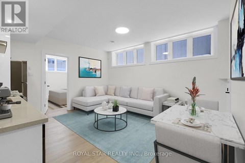 A living room with a white couch and a coffee table.