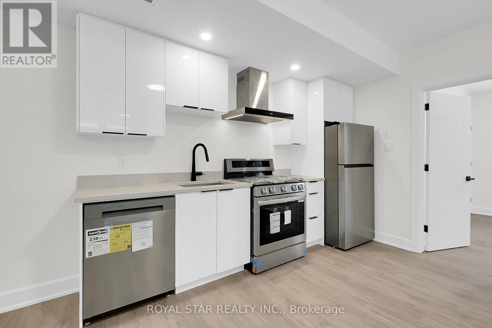 A kitchen with white cabinets and stainless steel appliances.