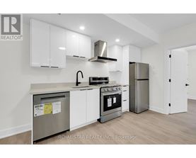 A kitchen with white cabinets and stainless steel appliances.