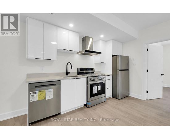 A kitchen with white cabinets and stainless steel appliances.