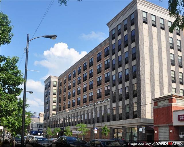 a large building with cars parked in front of it