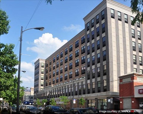 a large building with cars parked in front of it