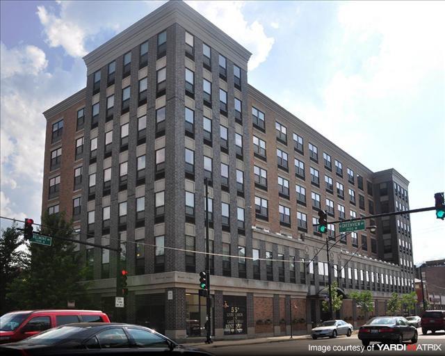a large building on the corner of a city street