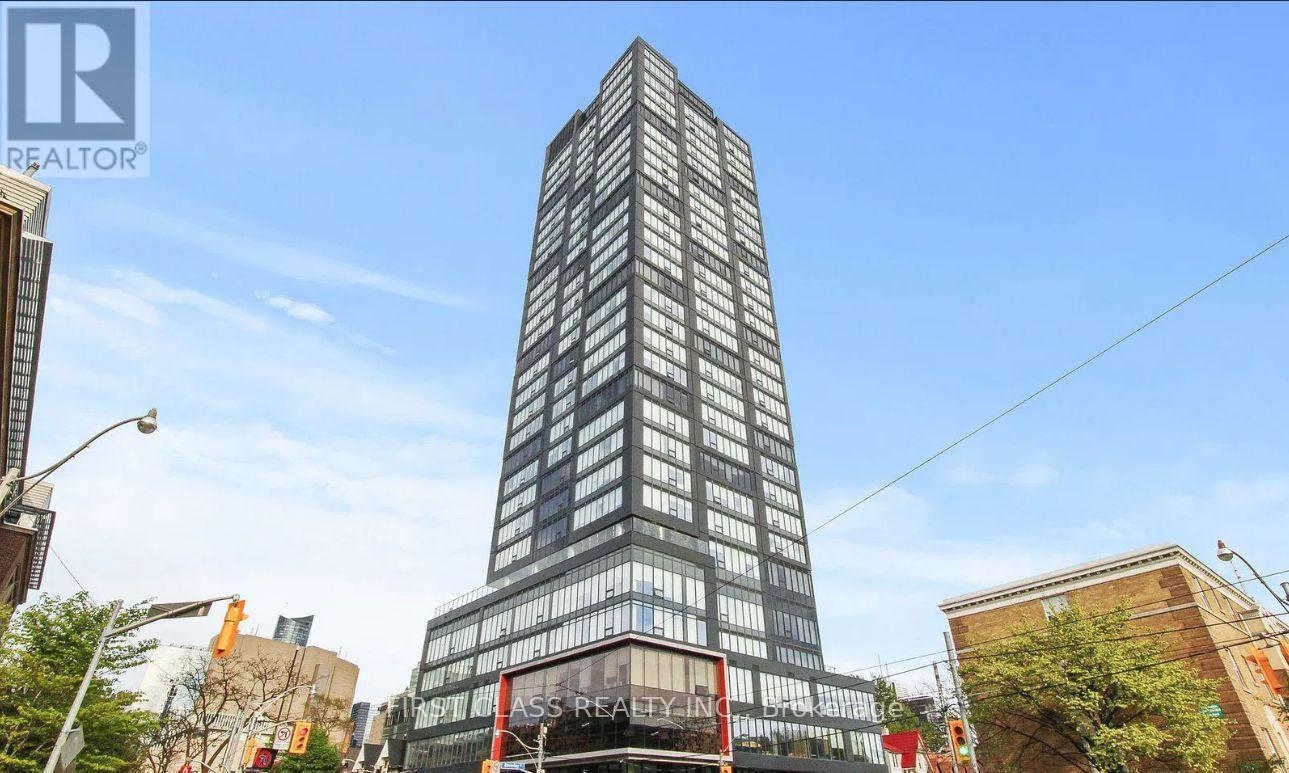 A tall building with the words "REALTOR" on it stands in the foreground of a city street.