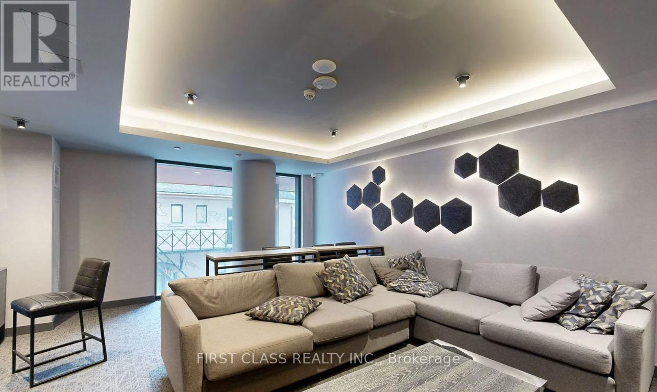 A modern living room with a grey sofa and a black chair.