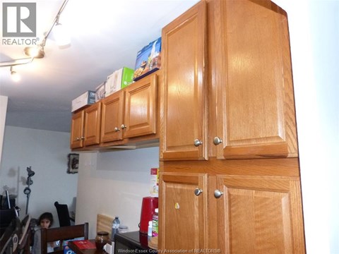 A kitchen with wooden cabinets and a dining table.