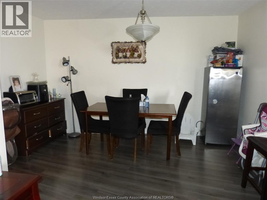 A dining room with a table and chairs.