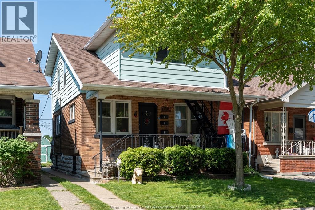 A house with a red and white flag on the front porch.
