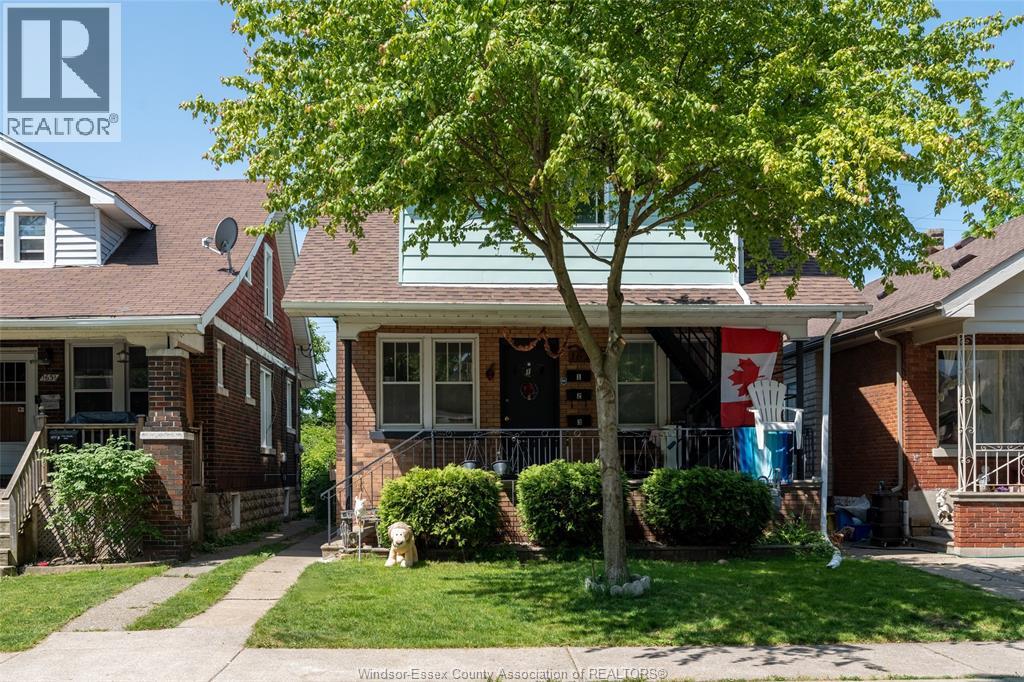A house with a tree in front of it.