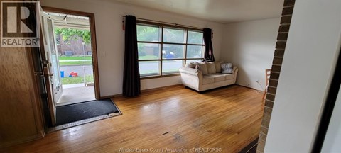 A living room with a couch and a window.