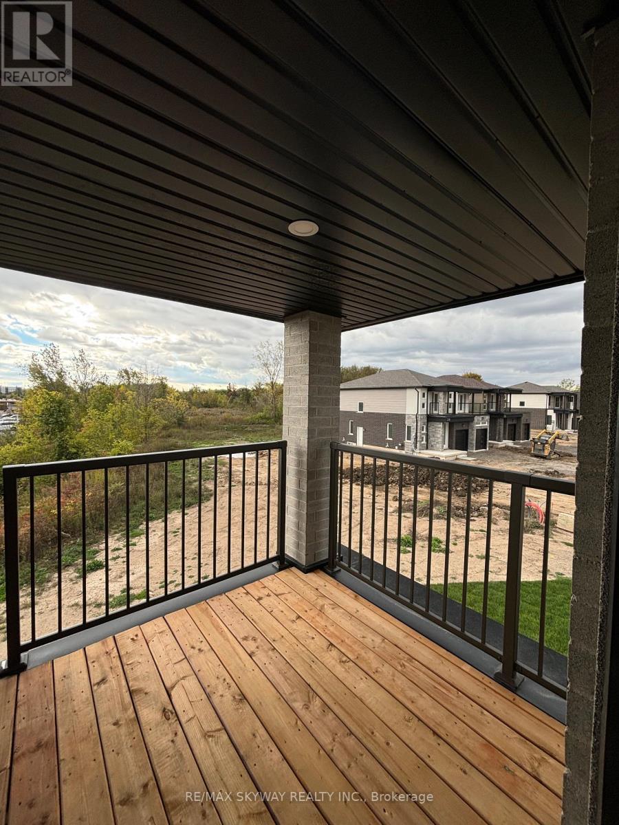 A balcony with a black railing and wooden floor.
