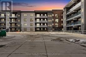 A building complex with a parking lot in front of it.